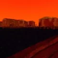 Low Frequency horror game town in the distance with an orange sky in the background